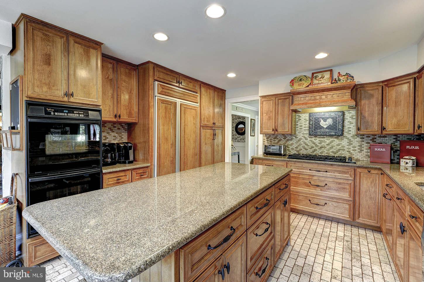10017 Chapel Road Potomac, MD 20854 - Photo 8 of 26 a kitchen with stainless steel appliances granite countertop a sink stove and refrigerator