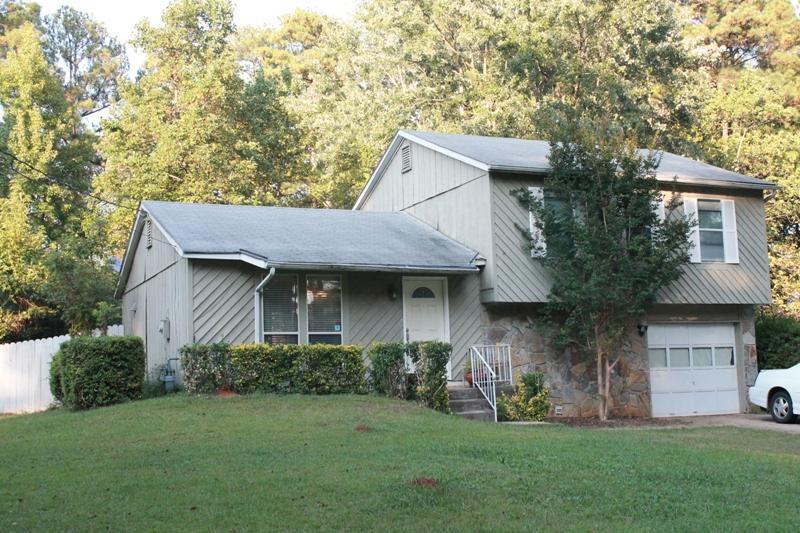 1093 Riva Ridge Drive Northwest, Unit 9 Norcross, GA 30093 - Photo 1 of 1 a front view of a house with a garden and yard