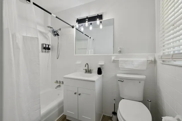 an aerial view of a residential houses with outdoor space and river