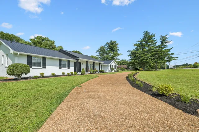 a kitchen with cabinets stainless steel appliances a sink and a window