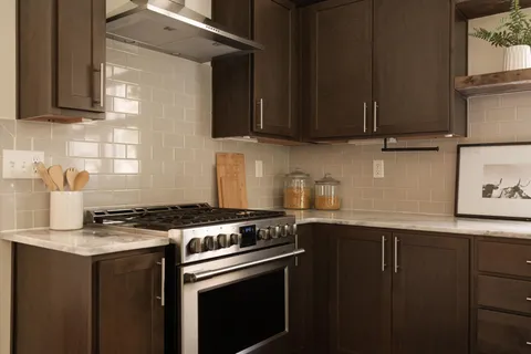 a kitchen with a sink a stove and cabinets