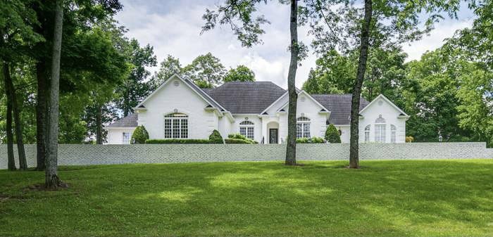 a front view of house with yard and green space
