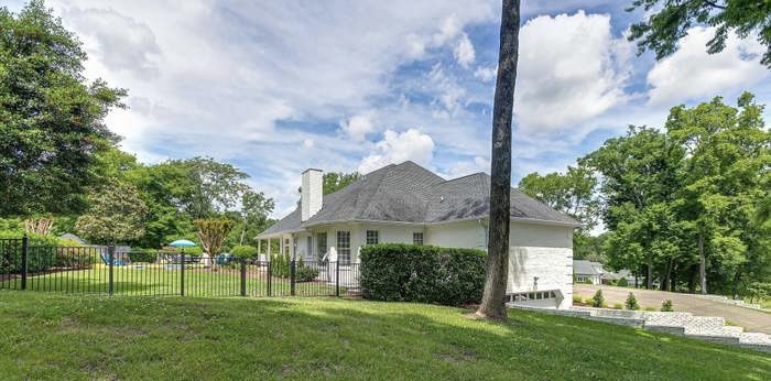 4675 Everal Lane Franklin, TN 37064 - Photo 13 of 15 a view of a house with a big yard and a large trees