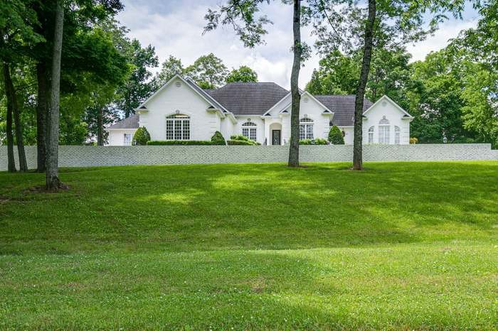 4675 Everal Lane Franklin, TN 37064 - Photo 2 of 15 a front view of a house with a yard and trees