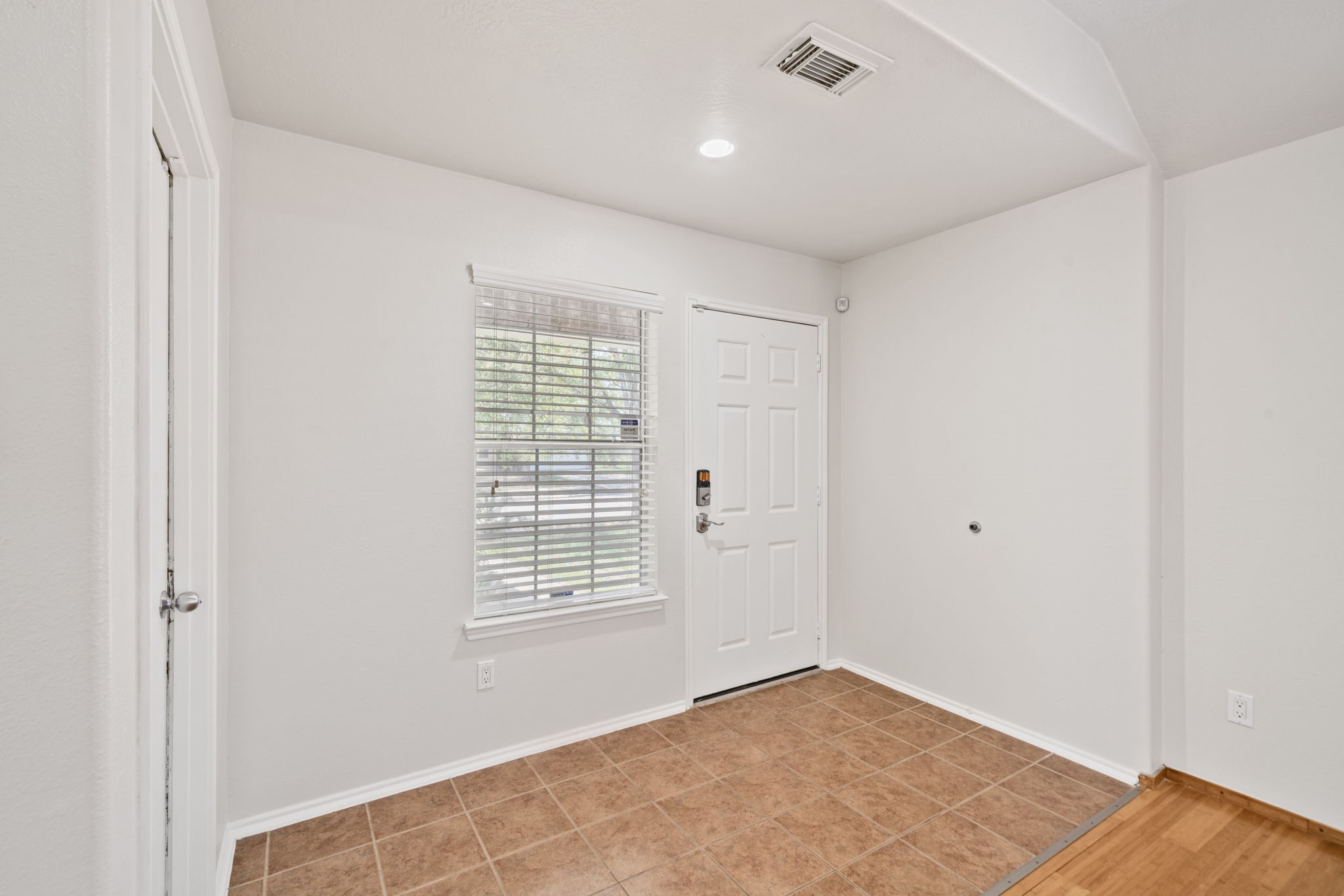 14323 Brunswick Point Lane Houston, TX 77047 - Photo 4 of 33 a view of an empty room with wooden floor and a window