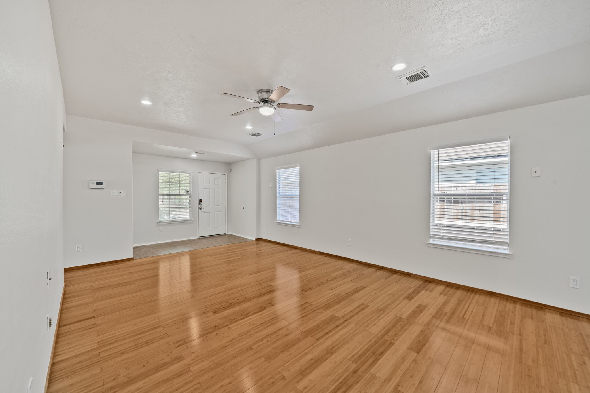 14323 Brunswick Point Lane Houston, TX 77047 - Photo 7 of 33 wooden floor in an empty room with a window