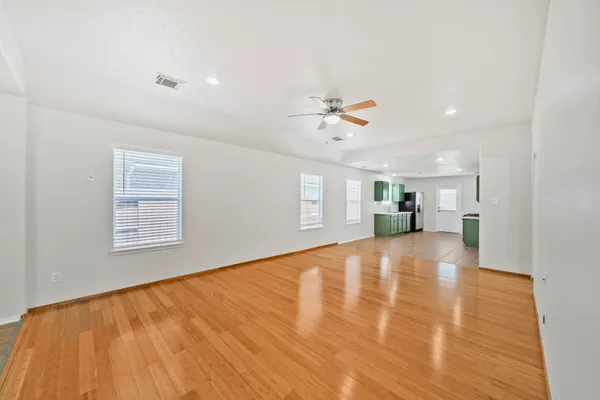 a kitchen with stainless steel appliances granite countertop a sink and a stove top oven with wooden floor