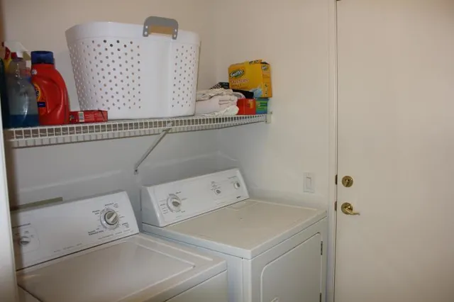 a view of a patio with table and chairs