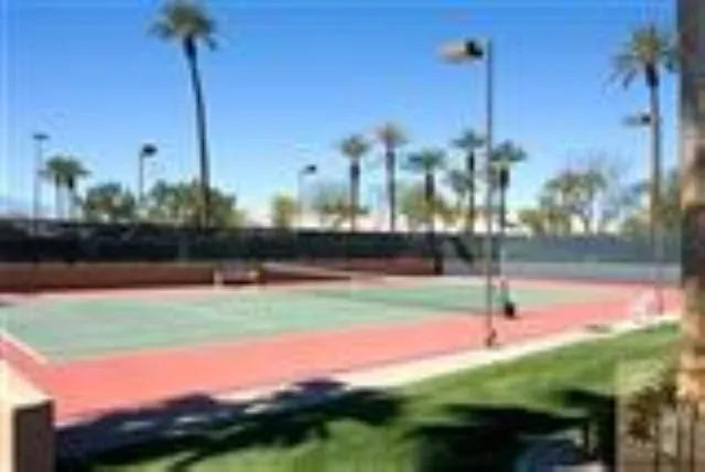 a living room with furniture a rug and a large window