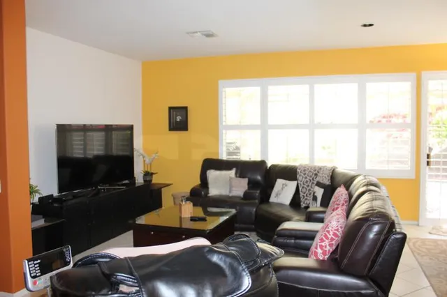 a living room with furniture and a flat screen tv