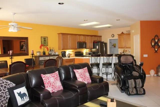 a living room with furniture and a floor to ceiling window