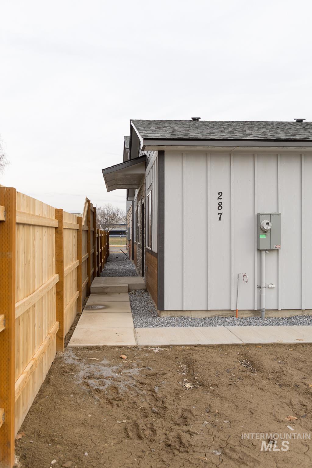 View of home's exterior with board and batten siding and a shingled roof