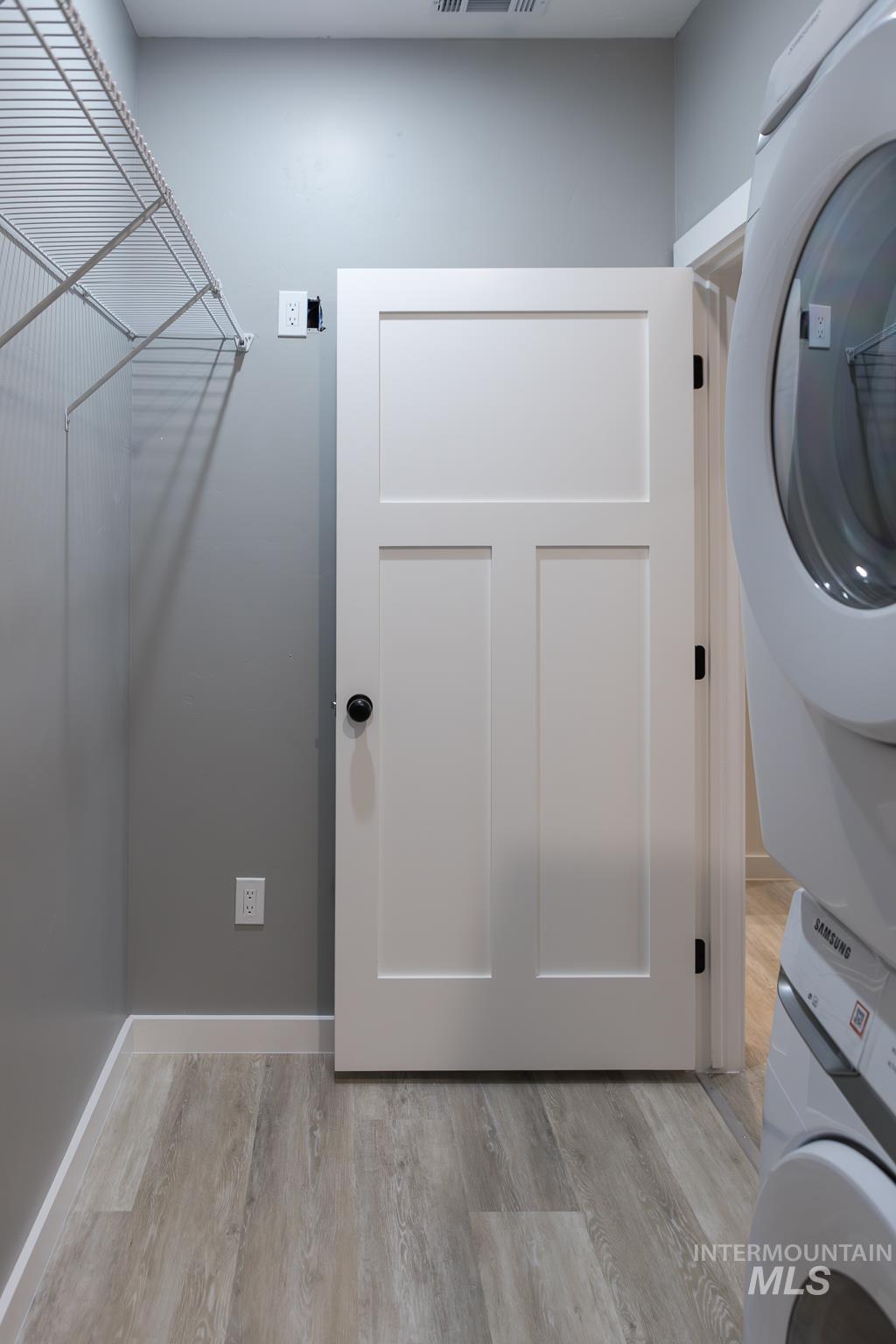 287 Southwest 6th Street, Unit 2 Ontario, OR 97914 - Photo 23 of 37 Laundry area featuring stacked washer / dryer and light wood-type flooring