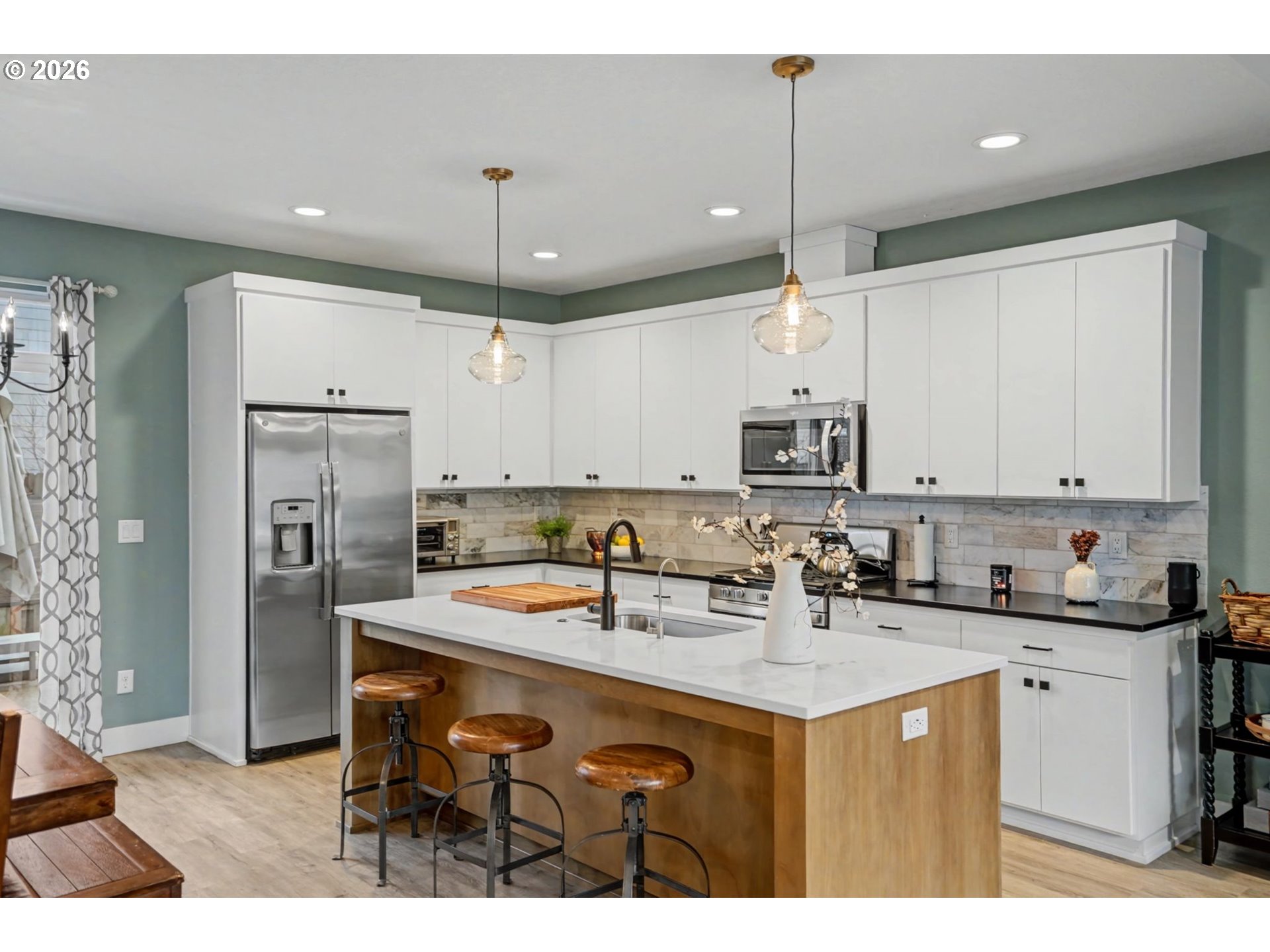 5520 Crossler Meadow Loop South Salem, OR 97306 - Photo 12 of 40 a kitchen with kitchen island a sink stainless steel appliances and cabinets