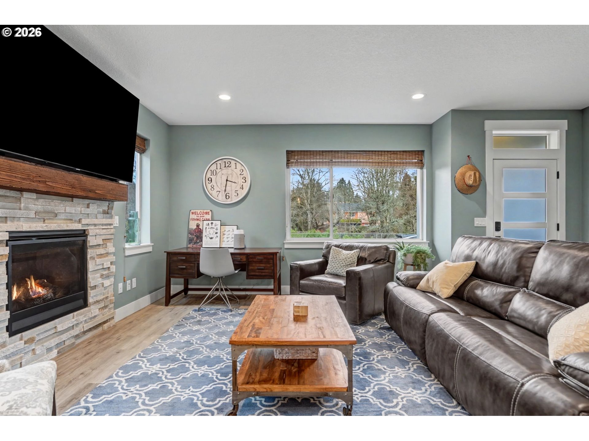 5520 Crossler Meadow Loop South Salem, OR 97306 - Photo 37 of 40 a living room with furniture a fireplace and a flat screen tv