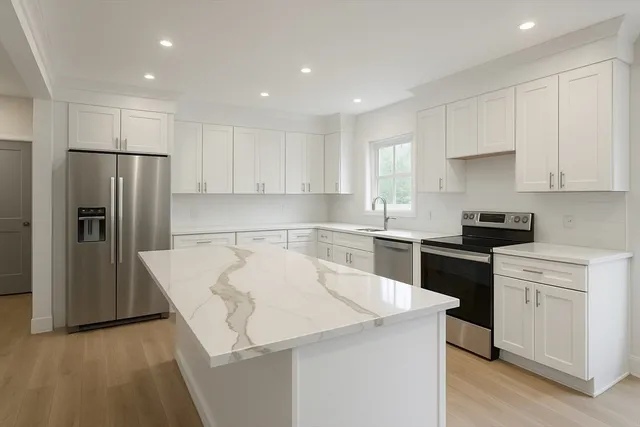 a kitchen with a refrigerator a sink and cabinets