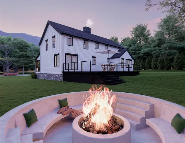 a view of a house with a yard deck and a garden