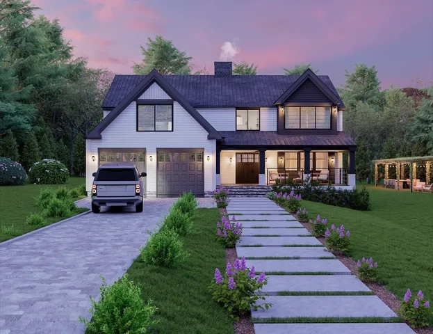 a front view of a house with a yard and garden