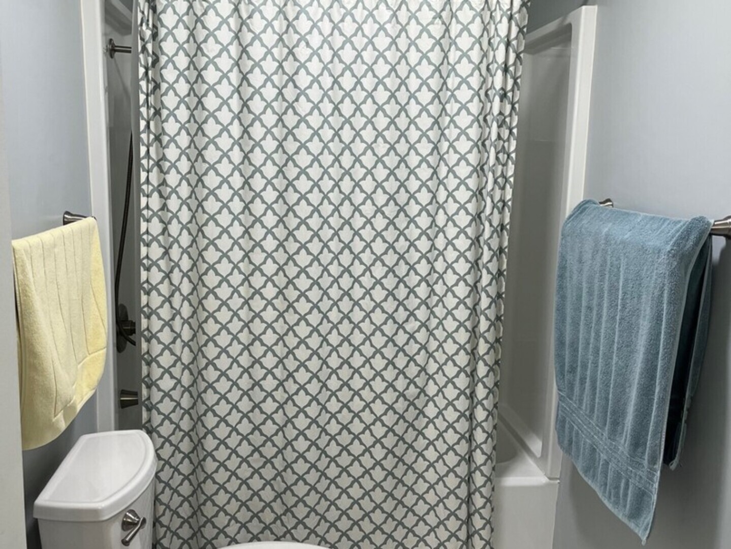 1690 Darwin Court Wheaton, IL 60189 - Photo 13 of 17 a white toilet sitting next to a shower curtain