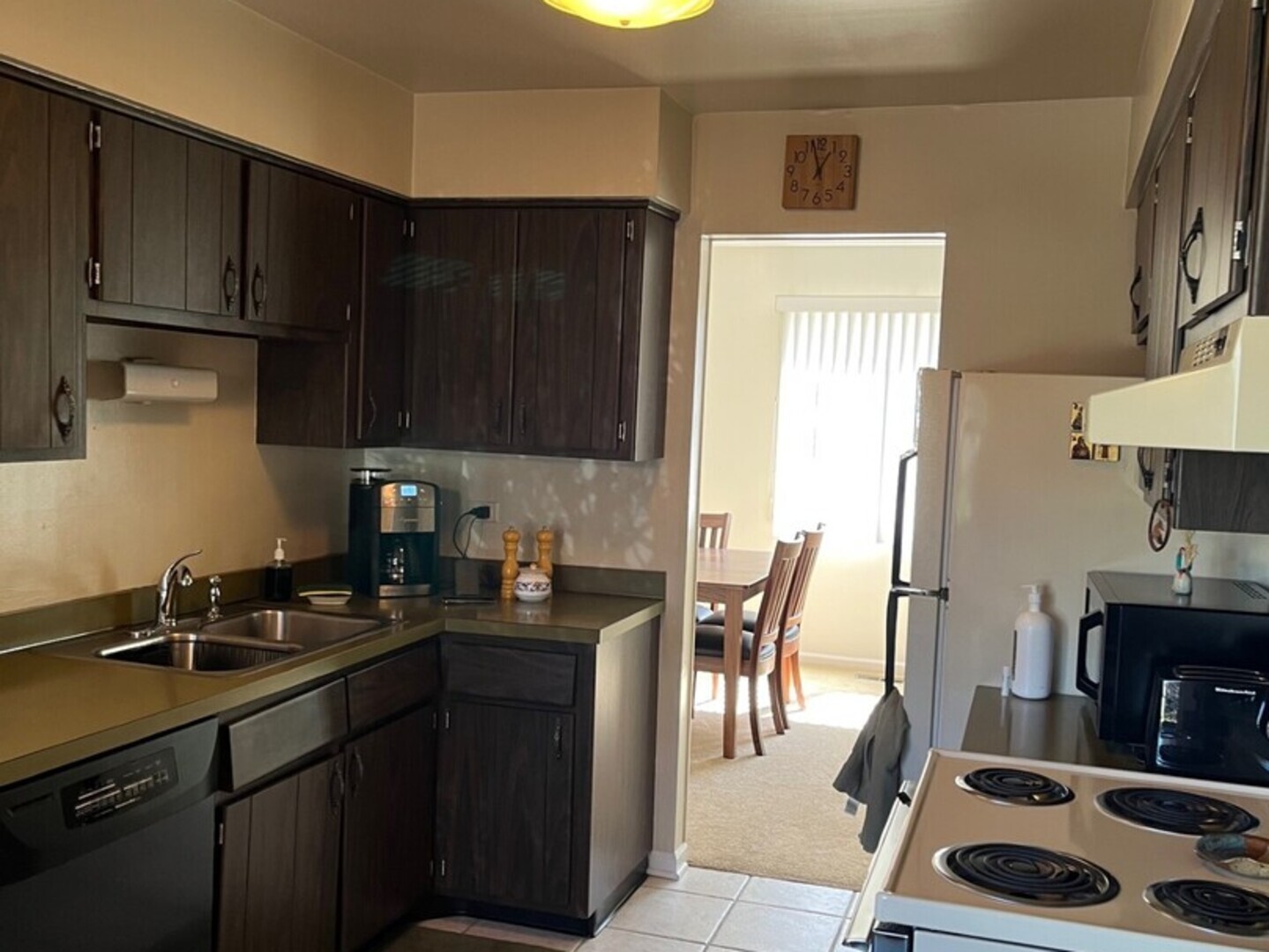 1690 Darwin Court Wheaton, IL 60189 - Photo 3 of 17 a kitchen with granite countertop a sink a stove and wooden cabinets