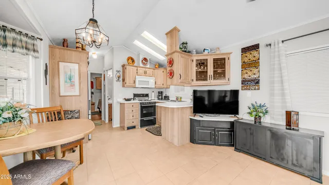 a kitchen that has a lot of cabinets and stainless steel appliances