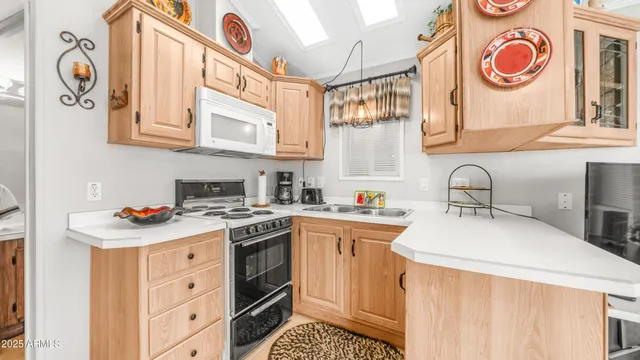 a kitchen with stainless steel appliances white cabinets and a stove top oven