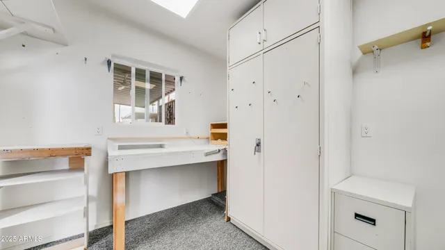 a view of a porch with a door and a barbeque