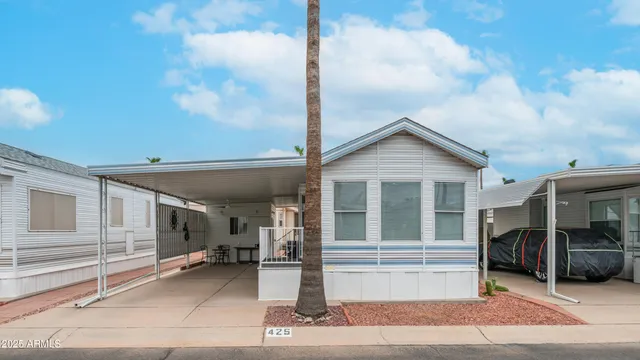 a small white house with a large window and wooden floor