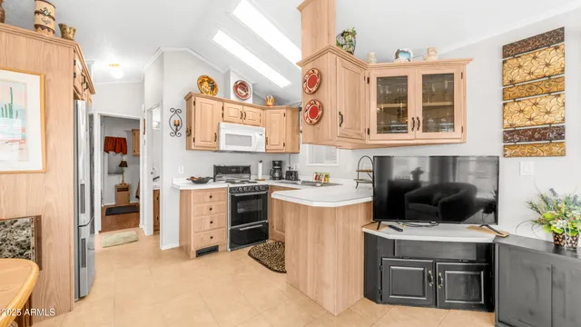 a kitchen with stainless steel appliances granite countertop a sink and cabinets