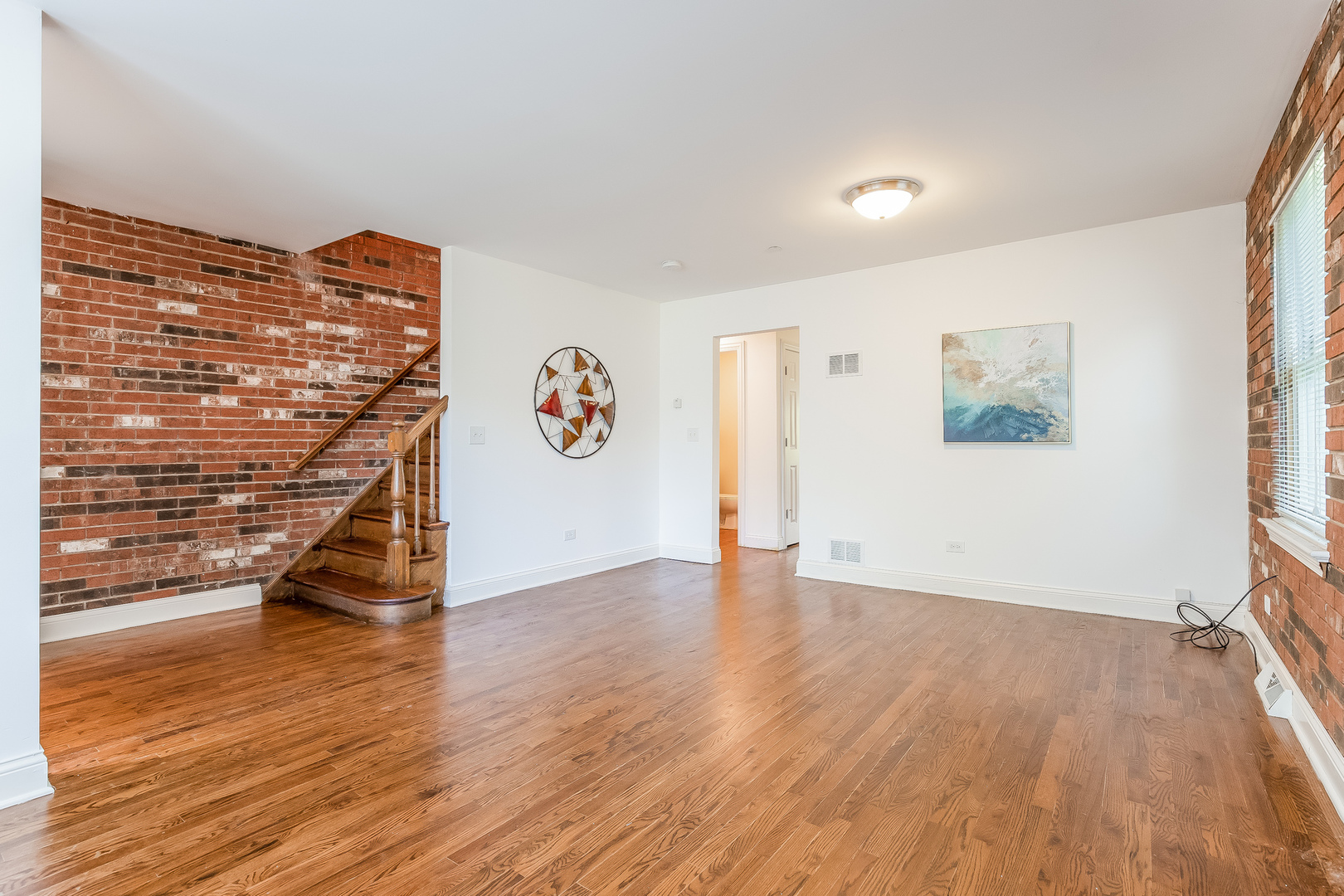 820 Green Bay Road Highwood, IL 60040 - Photo 3 of 16 an empty room with wooden floor and windows