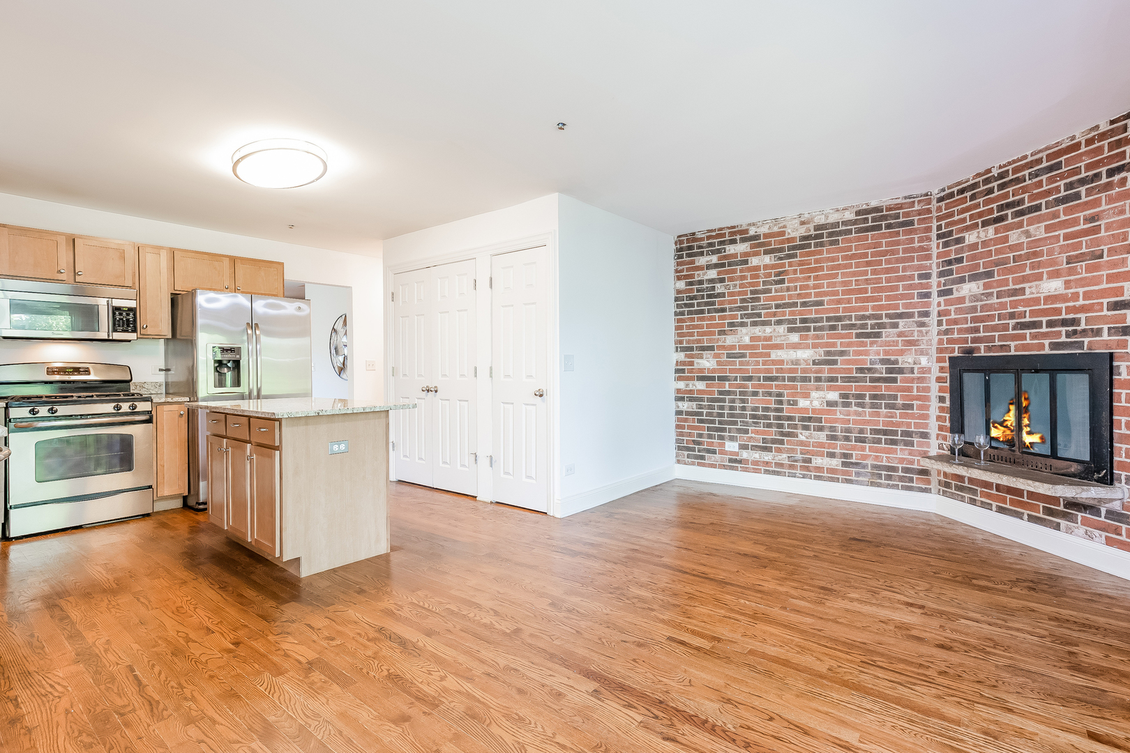 820 Green Bay Road Highwood, IL 60040 - Photo 7 of 16 a view of kitchen with stainless steel appliances wooden floor and living room view