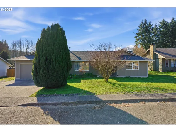 a view of a house with a yard and tree s
