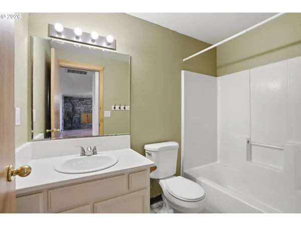 a bathroom with a sink toilet a mirror and shower