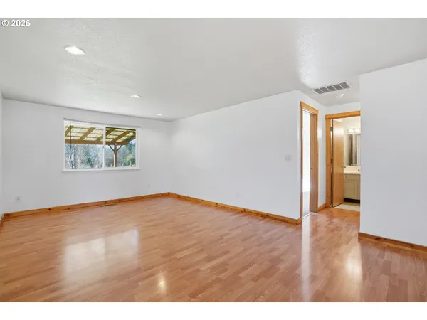 a view of an empty room and wooden floor