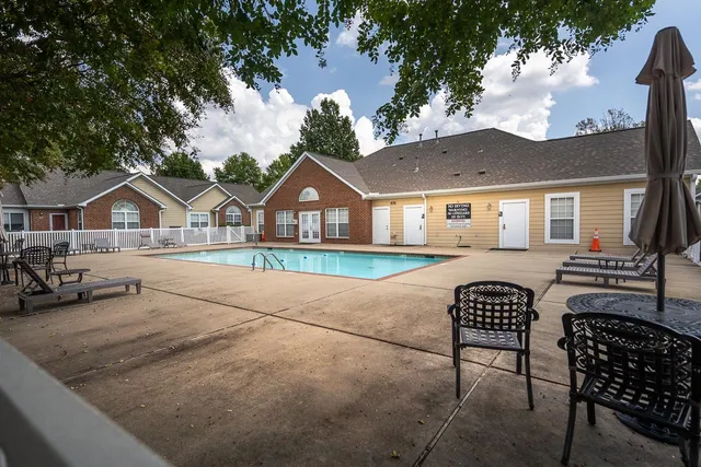 a view of house with outdoor space and sitting area