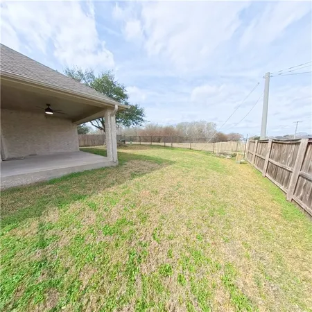 a view of a large pool with an outdoor space and seating area