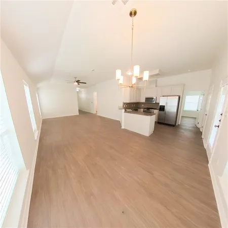 a view of a living room and kitchen with furniture
