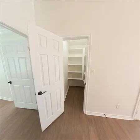 a view of a room with wooden floor