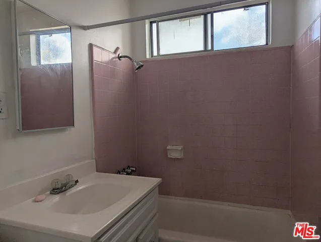 a bathroom with a sink and shower