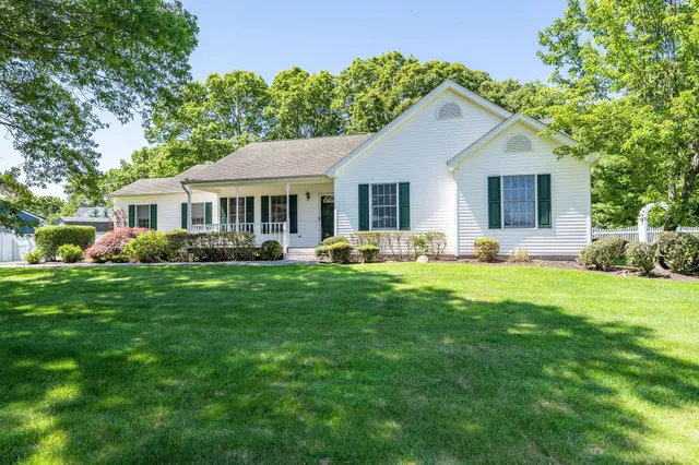 a front view of house with yard and green space
