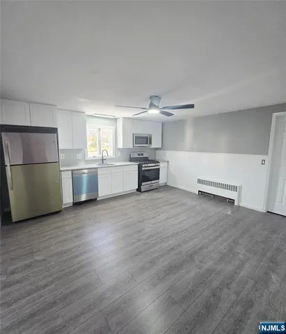 a kitchen with a refrigerator and a stove top oven