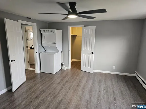 a view of empty room with wooden floor