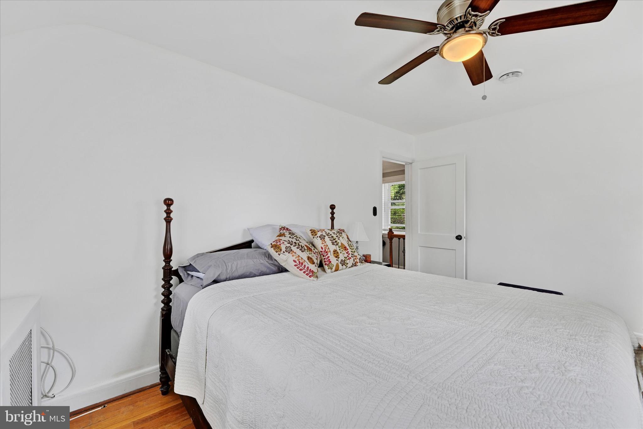 619 Warwick Road Baltimore, MD 21229 - Photo 15 of 41 a bedroom with a bed and wooden floor