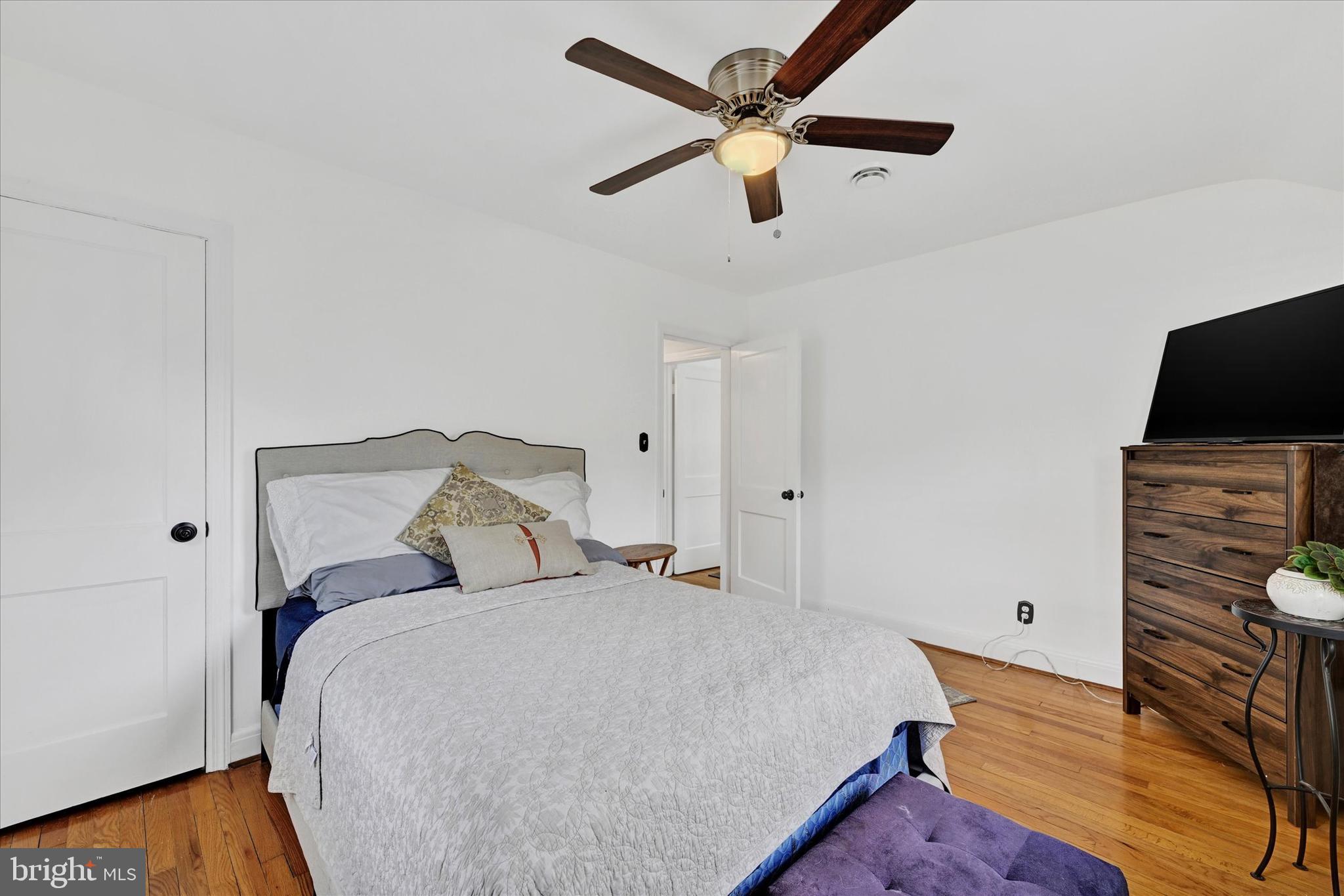 619 Warwick Road Baltimore, MD 21229 - Photo 17 of 41 a bedroom with a bed and a flat screen tv