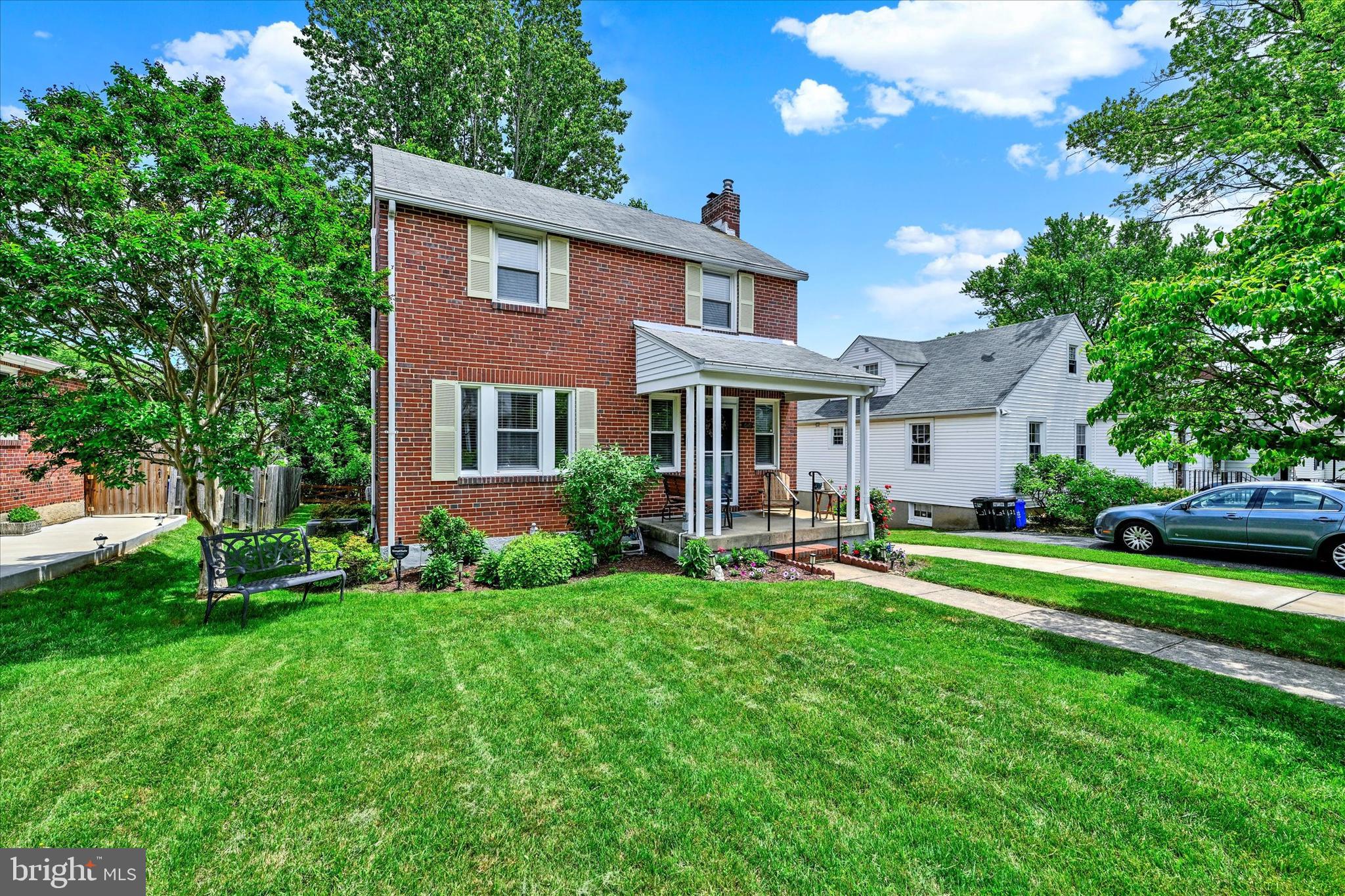 619 Warwick Road Baltimore, MD 21229 - Photo 2 of 41 a front view of a house with a yard table and chairs