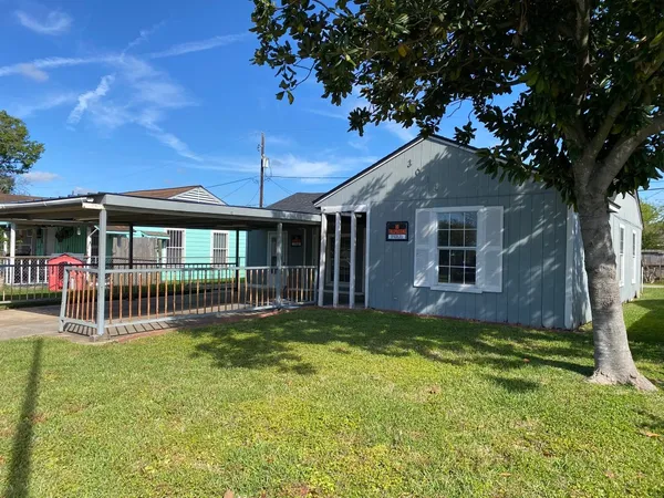 a house with green field in front of it