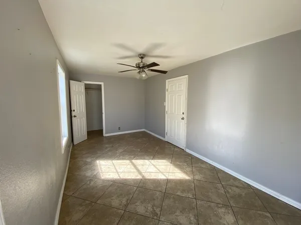 a view of a livingroom with a ceiling fan and window