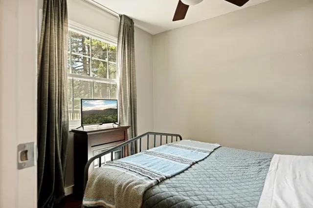 a bedroom with a bed and window