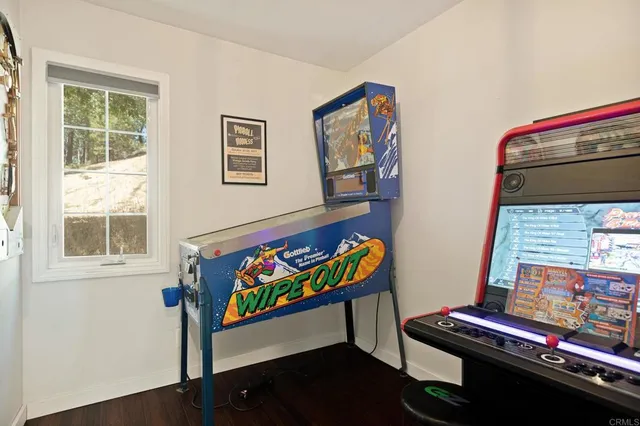 wooden floor with table and chairs