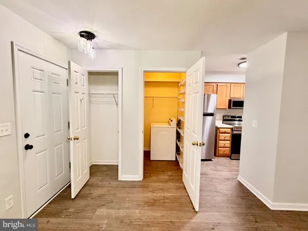 a view of a kitchen with a refrigerator and a sink